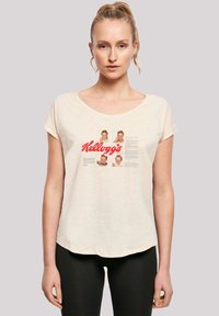 Cream short-sleeve T-shirt with a rounded neckline, featuring Kellogg's logo and vintage images and text in red and black print.
