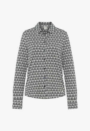 Camicia a maniche lunghe con bottoni, motivo a ventaglio nero e bianco ripetuto e colletto appuntito, distesa su sfondo bianco.