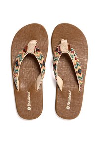 Chanclas marrones con suela texturizada, que presentan tiras de tela tejida multicolor en un patrón en zigzag. Nombre de la marca impreso en la plantilla.