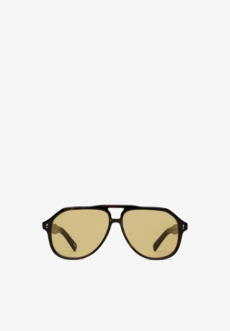 Braune Schildpatt-Sonnenbrille mit hexagonalen Gläsern. Verfügt über ein einzigartiges Brückendesign und dunkelbraune Bügel mit dezentem Branding an der Fassung.