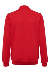 Veste rouge à manches longues en tissu texturé, avec un col, des poignets côtelés et un dos uni sans logos ni motifs visibles.