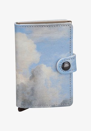 Blue leather wallet with cloud pattern, metal snap closure, and curved corners. Surface has a textured, worn finish, enhancing the design.