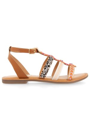 Brown flat sandals featuring a T-strap design with multicolored beaded accents, embossed patterns, and an adjustable buckle strap.
