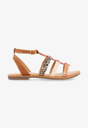 Brown flat sandals featuring a T-strap design with multicolored beaded accents, embossed patterns, and an adjustable buckle strap.