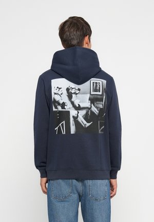 Navy hoodie with a large black and white graphic on the back depicting two stormtroopers sitting. Soft fabric, relaxed fit, and kangaroo pocket.