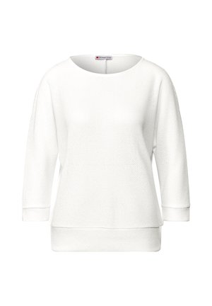 White long-sleeve sweater with a loose fit, round neckline, textured knit pattern, and ribbed cuffs and hem. Brand label visible at neck.