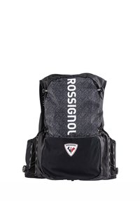 Zaino nero con parte superiore a fantasia, caratterizzato dal logo "ROSSIGNOL" in bianco. Include tasche laterali e una toppa a forma di triangolo sul davanti.