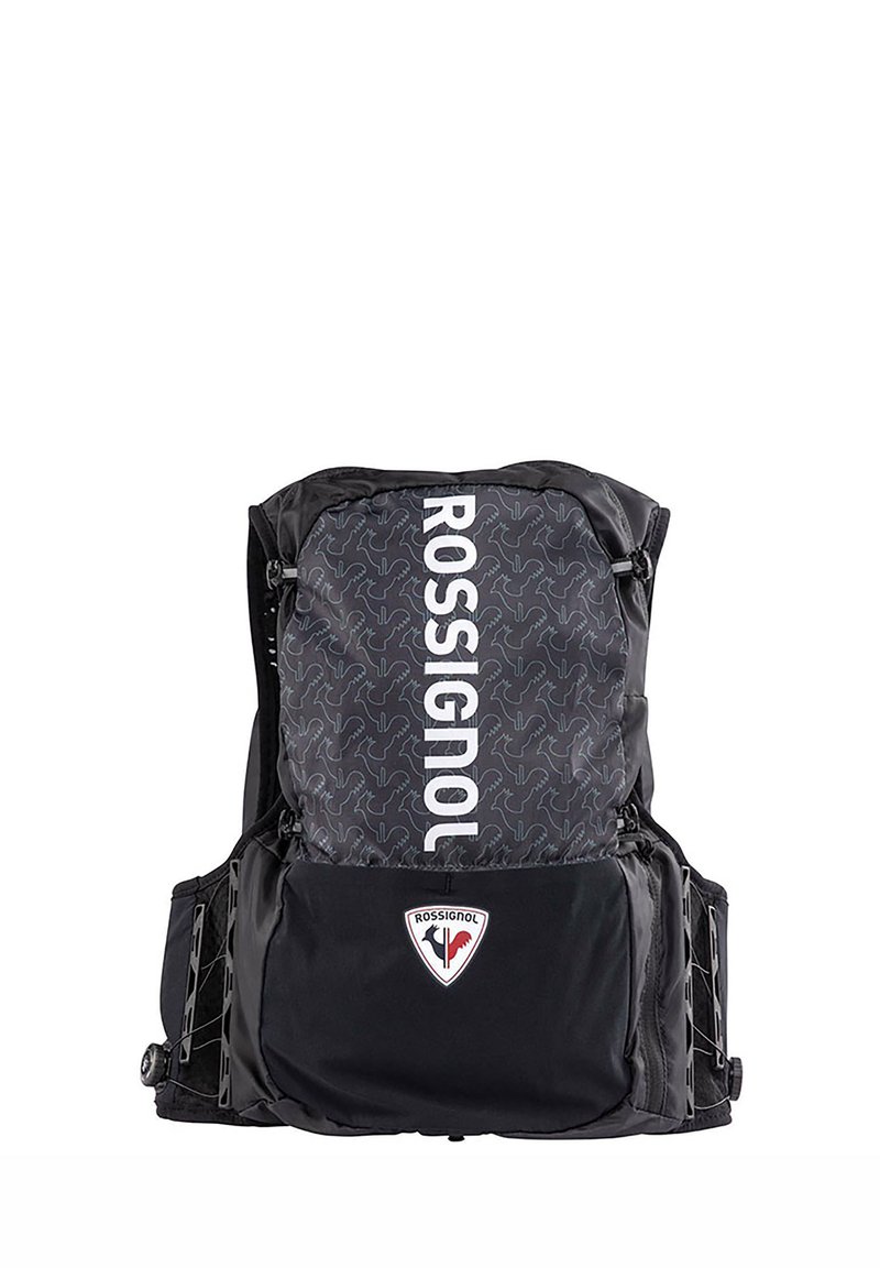 Zaino nero con parte superiore a fantasia, caratterizzato dal logo "ROSSIGNOL" in bianco. Include tasche laterali e una toppa a forma di triangolo sul davanti.