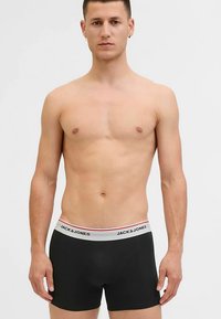 Black boxer briefs with a white waistband featuring the "JACK & JONES" logo, smooth texture, and fitted design.