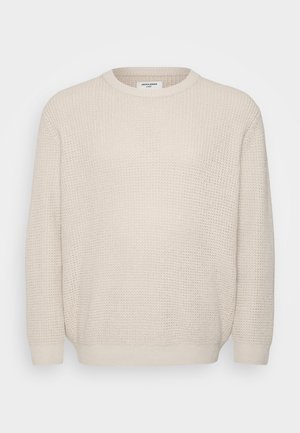 Off-white knitted sweater with a round neckline, ribbed cuffs, and hem. Features a textured pattern throughout the fabric.