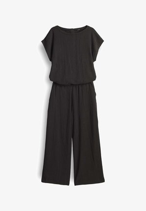 Tuta nera realizzata in tessuto testurizzato, con un top morbido a maniche corte e pantaloni a gamba larga. Design semplice, senza motivi.