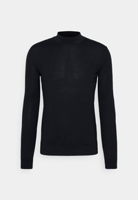 Pull noir à col roulé à manches longues, en tissu tricot doux, avec une silhouette ajustée et des poignets côtelés, arborant un logo subtil à l'ourlet.