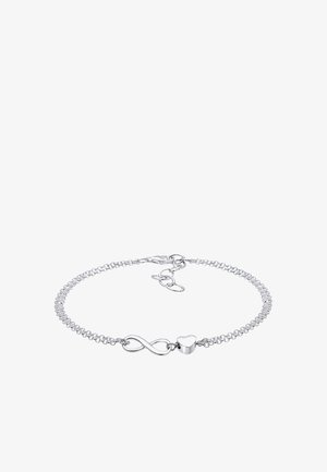 Bracelet en chaîne argentée avec symbole infini et breloque en forme de cœur, doté d'un fermoir mousqueton et de maillons réglables.