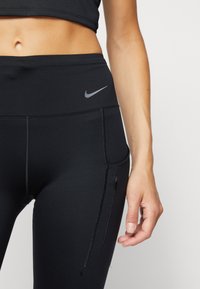 Nike Performance W NK DF GO MR 7/8 TGHT - Leggings - black