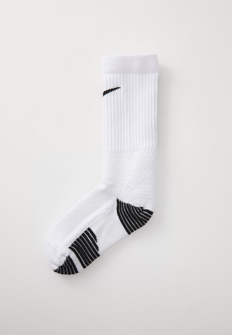 White athletic sock with ribbed texture, black Nike logo, and striped black accents near the toe and heel.