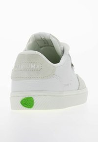 Białe trampki z gładkiej skóry i zamszowymi akcentami. Posiadają zielone logo z gumy na podeszwie oraz wyściółkę wokół kostki dla komfortu.