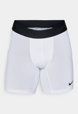 Vita Nike Pro idrottsshorts med svart elastisk midja, som har Nike-logotypen i svart. Slät tyg med en åtsittande passform.