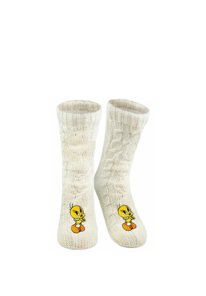 Cremefarbene, kabelgestrickte Socken mit dem gestickten Cartoon-Charakter Tweety Bird nahe den Zehen.