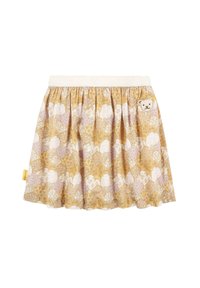 Jupe dorée et blanche à motifs avec une taille élastique, présentant un petit détail de ours cousu et un design floral distinctif.