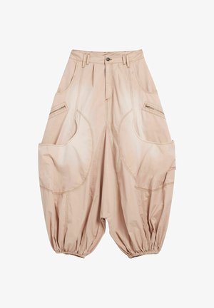 Beige Baggy-Hosen aus leichtem Material, mit großen Taschen, elastischen Bündchen und sichtbaren Nahtakzenten.