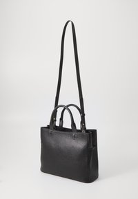Black textured leather handbag with dual top handles and a long adjustable strap. Features a structured shape and minimal hardware accents.