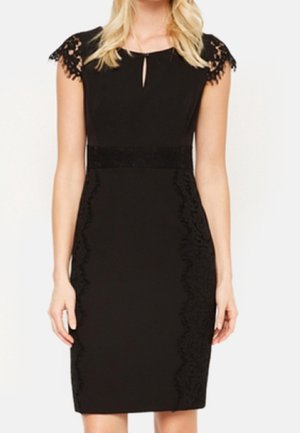 Sort knælængde kjole med blonder på kappelærmer, nøglehulshalsudskæring, taljeret pasform og blonde detaljer langs siderne.