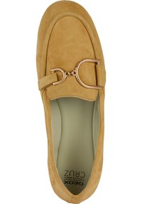 Mocassini in suede beige con punta arrotondata, dotati di una catena in tono oro sulla parte anteriore e una soletta liscia di colore chiaro.