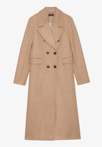 Beige, dubbelzijdig jasje met een gelapte kraag, gemaakt van een zachte stof. Heeft zwarte knopen en twee voorzakken. Lange mouwen.