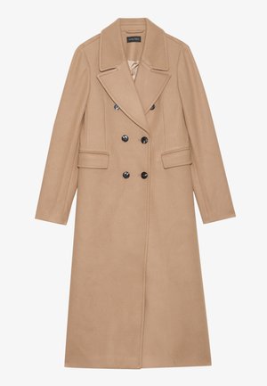 Beige, dobbelspent kåpe med notched krage, laget av et mykt stoff. Har svarte knapper og to fork pocket. Langermet design.