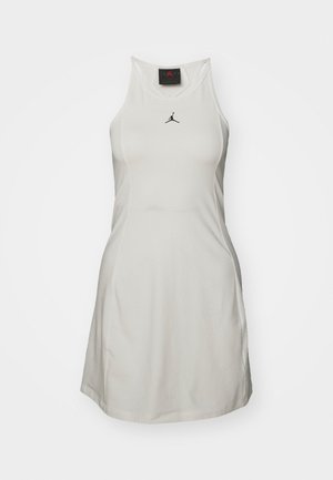 Hvid sportskjole med racerback-design, der har et sort Jordan-logo på brystet. Fremstillet af let, glat stof.