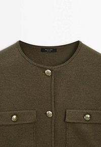 Olive green knitted cardigan with crew neckline, featuring two chest pockets, gold-tone buttons, and a tag labeled "Massimo Dutti."