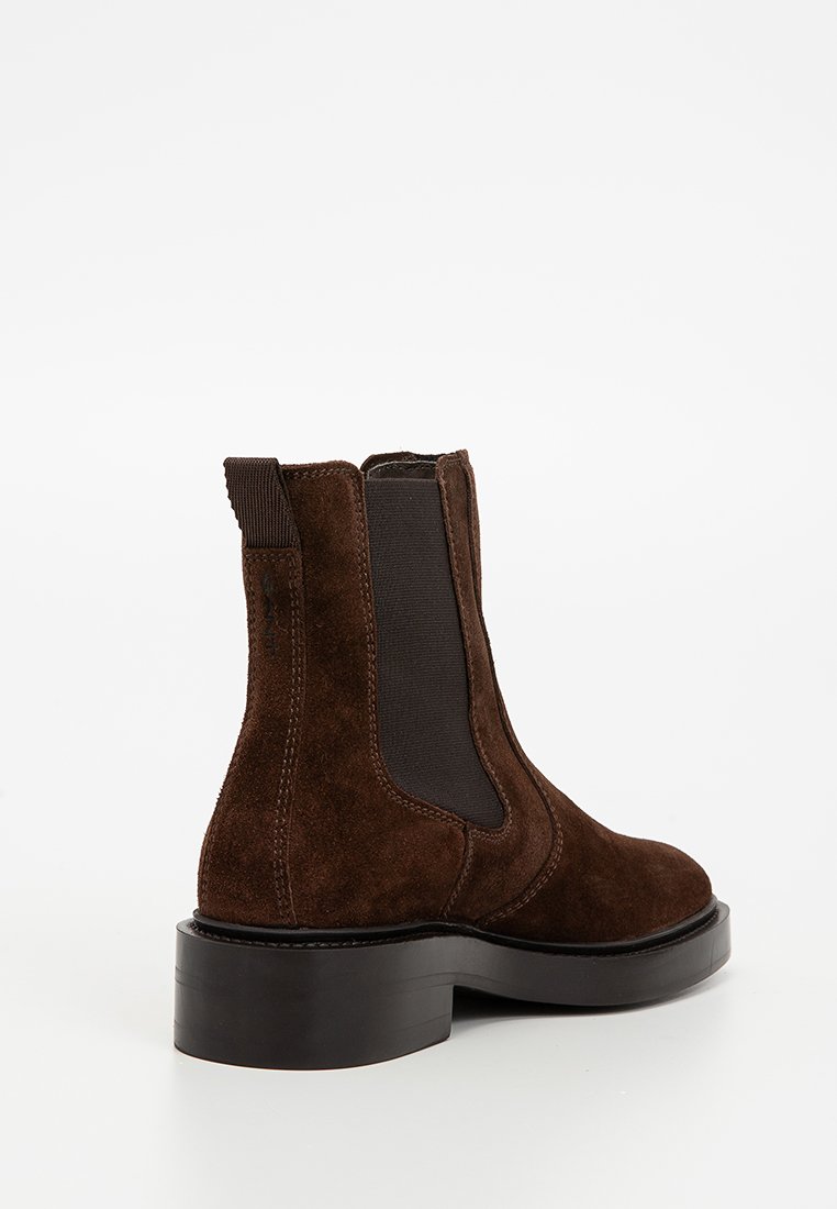 Braune Wildleder-Stiefelette mit elastischen Seitenteilen, runder Zehenform und kräftiger schwarzer Gummisohle. Glatte Textur und elegantes Design.