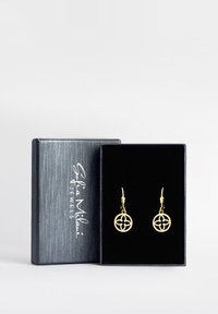 Guldörhängen med en cirkulär, öppnad design som har ett blommönster. Förpackade i en svart texturerad låda med en mjuk insida.