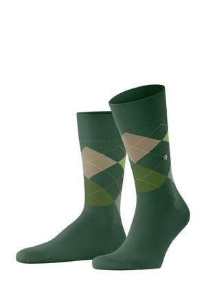 Green socks featuring an argyle pattern in varying shades of green and beige, with yellow stitching accents. Cotton blend fabric.