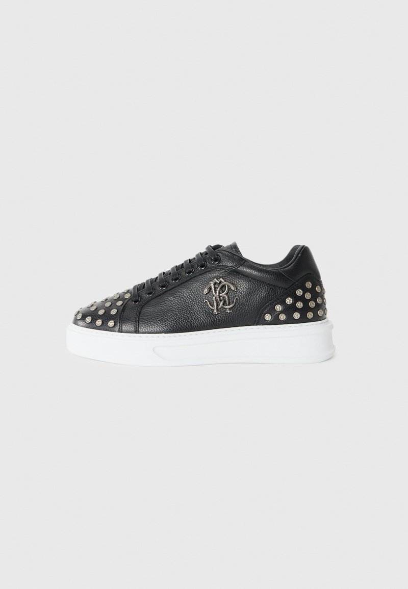 Black leather sneakers featuring silver studs on the toe and heel, a white sole, and embossed logo on the side. Round laces included.