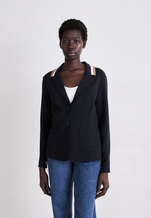 Navy blazer with two front pockets, black buttons, and a textured collar in tan and cream. Tailored fit, long sleeves, minimal design.