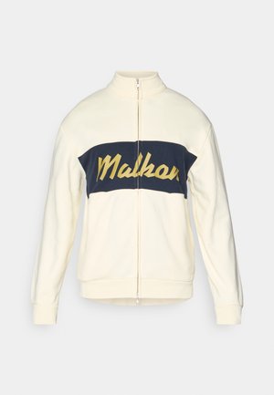 Cream zip-up jacket with high collar, navy horizontal color block featuring yellow "Malkar" text in script. Soft fabric with ribbed cuffs.