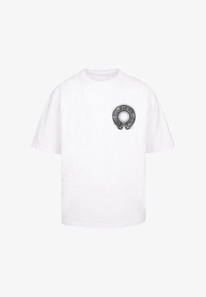 Camiseta de algodón blanco de manga corta con un gráfico circular en negro y gris en la parte izquierda del pecho, que se asemeja a un anillo.