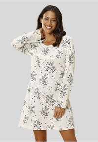 Nuisette à manches longues en tissu crème, ornée de motifs floraux noirs et roses, avec un col rond et une coupe décontractée en A.