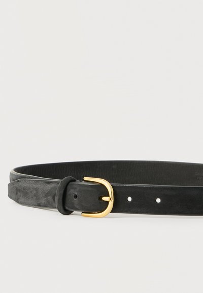Ceinture en cuir noir à texture lisse avec boucle en métal doré, posée à plat sur un fond blanc.