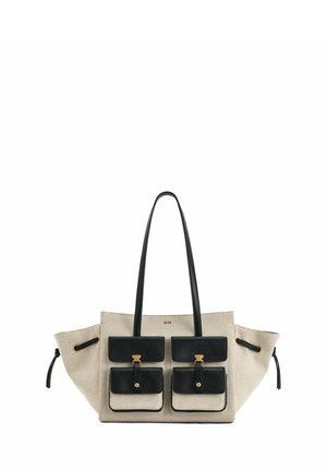 Sac fourre-tout en toile beige avec poignées en cuir noir, deux grandes poches avant avec fermoirs dorés, et détails à cordon de serrage sur les côtés.