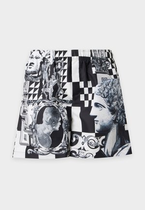 Zwart-witte shorts met prints van klassieke standbeeldenhoofden, ingewikkelde lijsten, geometrische vormen en decoratieve ontwerpen.