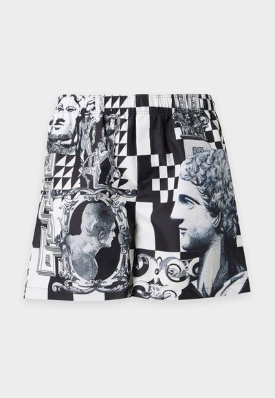 Shorts noir et blanc avec des imprimés de têtes de statues classiques, de cadres complexes, de formes géométriques et de motifs ornementaux.