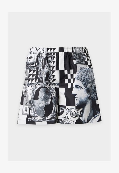 Shorts noir et blanc avec des imprimés de têtes de statues classiques, de cadres complexes, de formes géométriques et de motifs ornementaux.