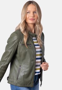 Olive green leather jacket with a fitted design, zippered pockets, and ribbed detailing on shoulders. Worn over a striped shirt.