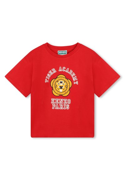 T-shirt en coton rouge avec un design graphique d'un tigre souriant entouré de fleurs, avec le texte "TIGER ACADEMY" et "KENZO PARIS" en dessous.