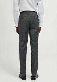 Pantaloni gri dintr-un material neted, cu un design cu picioare drepte, două buzunare la spate și detalii subtile de cusătură. Asortați cu o cămașă albă.