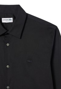 Black slim-fit button-up shirt with point collar and subtle black embroidered crocodile logo on the chest.