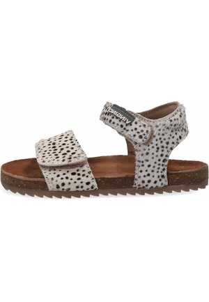 Open-toe sandal with adjustable straps, made of spotted grey and white faux fur. Features a brown textured footbed and rubber sole.