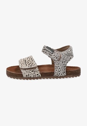 Open-toe sandal with adjustable straps, made of spotted grey and white faux fur. Features a brown textured footbed and rubber sole.
